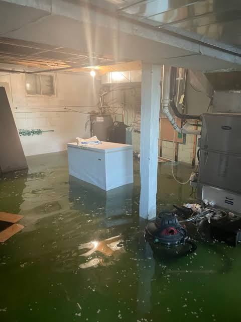 Deep standing floodwater inside flooded garage and ground-level utility area